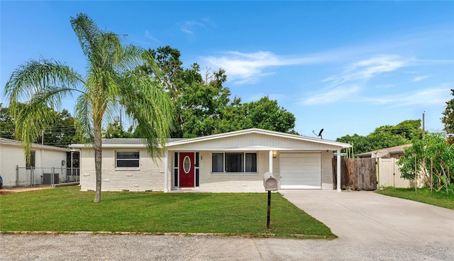 ranch-style house with a garage and a front lawn