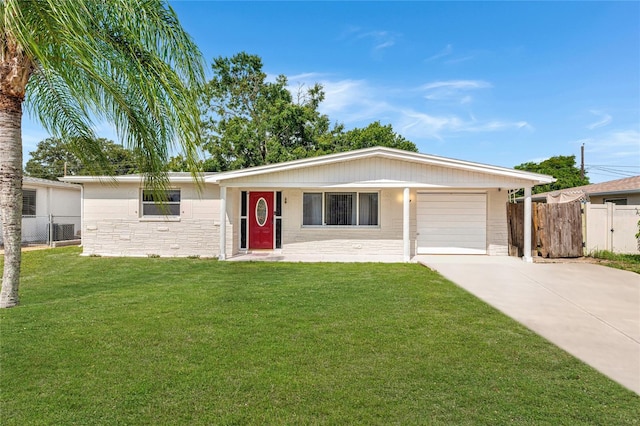 ranch-style house featuring a garage and a front yard