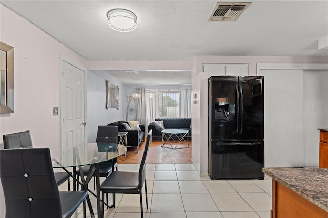 tiled dining area featuring a textured ceiling