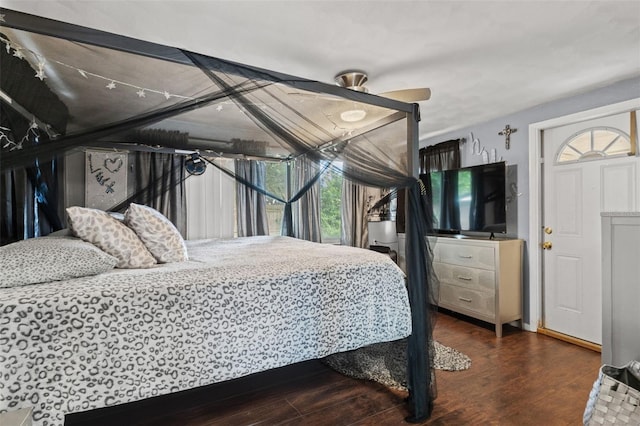 bedroom with ceiling fan and dark hardwood / wood-style floors