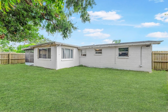 rear view of house with a yard