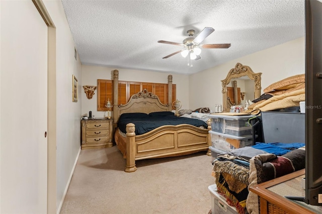 carpeted bedroom with ceiling fan and a textured ceiling