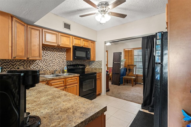 kitchen featuring tasteful backsplash, a textured ceiling, ceiling fan, light colored carpet, and black appliances