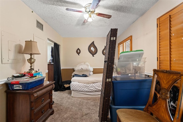 carpeted bedroom with a textured ceiling and ceiling fan