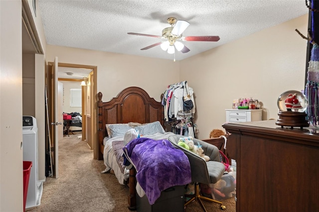 carpeted bedroom featuring ceiling fan and a textured ceiling