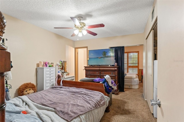 bedroom featuring a textured ceiling, a closet, ceiling fan, and carpet