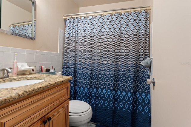 bathroom featuring tile walls, decorative backsplash, vanity, and toilet