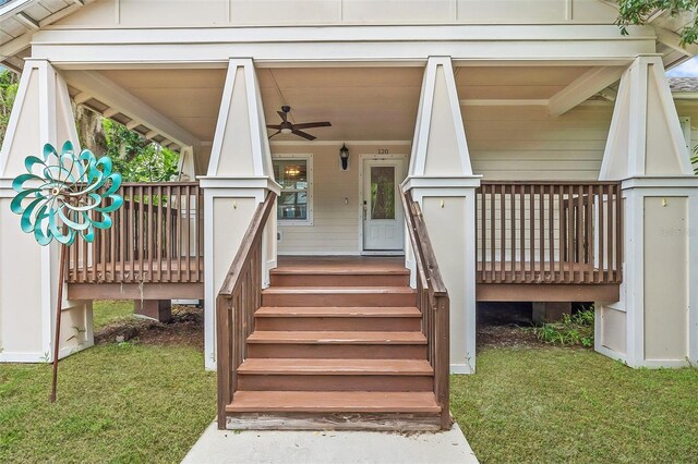 doorway to property featuring ceiling fan and a yard