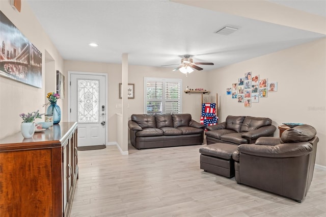 living room with light wood-type flooring and ceiling fan