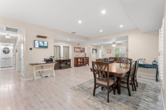 dining area with ceiling fan and light hardwood / wood-style floors