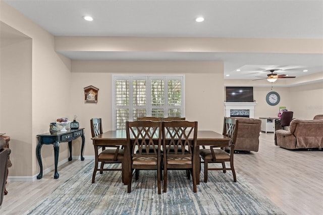 dining area featuring ceiling fan and light wood-type flooring