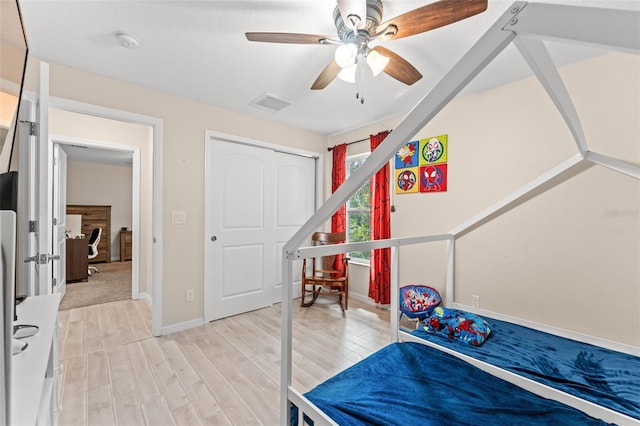 bedroom featuring a closet, ceiling fan, and light hardwood / wood-style floors