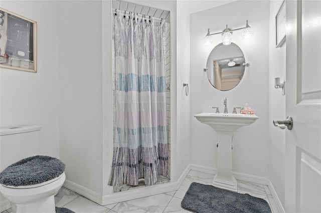 bathroom featuring toilet, a shower with curtain, and tile patterned floors