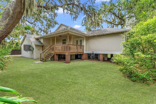 back of property featuring a yard and a deck