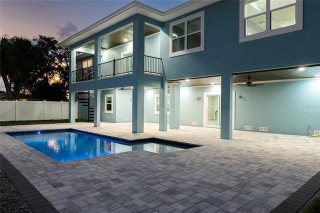 view of swimming pool with a fenced in pool, stairway, a patio area, fence, and ceiling fan