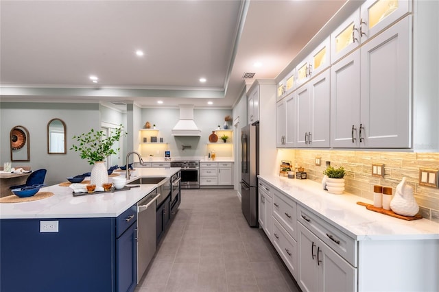 kitchen with backsplash, premium range hood, a spacious island, appliances with stainless steel finishes, and white cabinetry