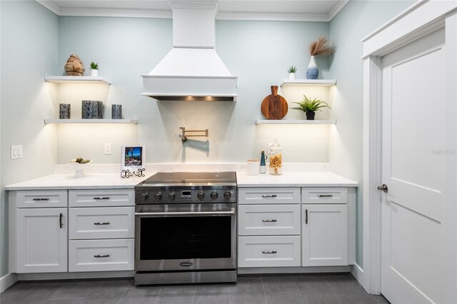 kitchen with stainless steel electric stove, custom exhaust hood, and crown molding