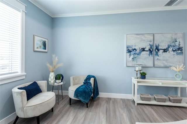 sitting room featuring hardwood / wood-style floors and ornamental molding