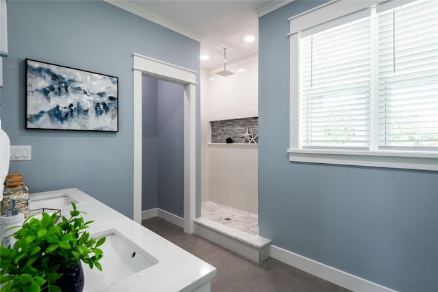 full bathroom featuring recessed lighting, ornamental molding, a sink, a walk in shower, and baseboards