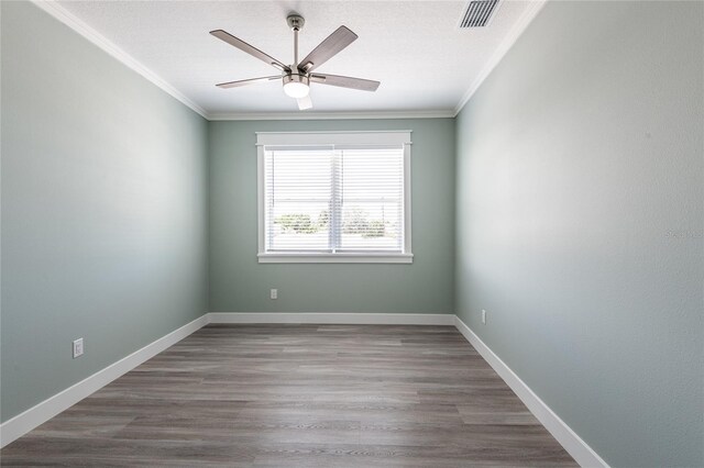 spare room with crown molding, hardwood / wood-style floors, and ceiling fan