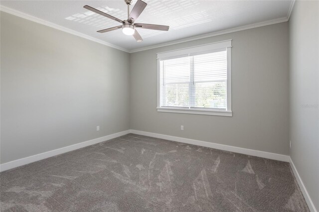 unfurnished room with ceiling fan, dark carpet, and ornamental molding