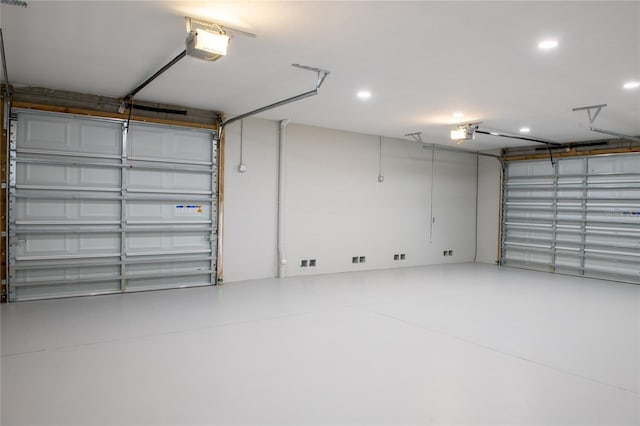 garage featuring a garage door opener and recessed lighting