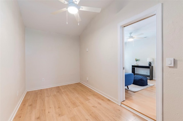 spare room with light wood-style flooring, baseboards, and a ceiling fan