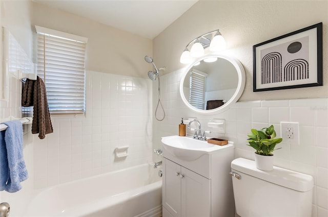 full bathroom featuring vanity,  shower combination, toilet, and tile walls