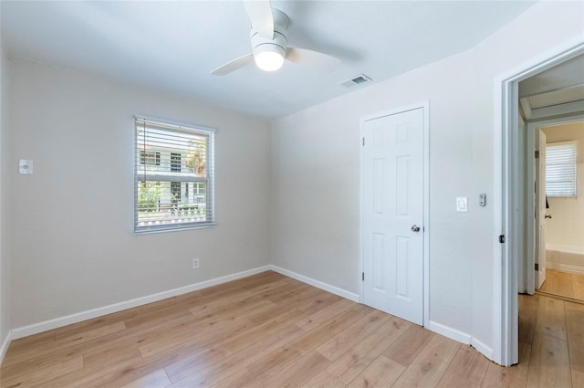 empty room with light wood-type flooring and baseboards