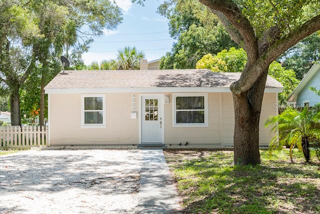 ranch-style house with fence