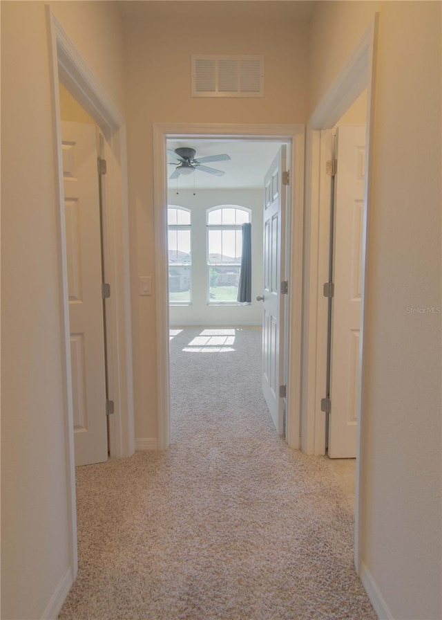 corridor with light colored carpet