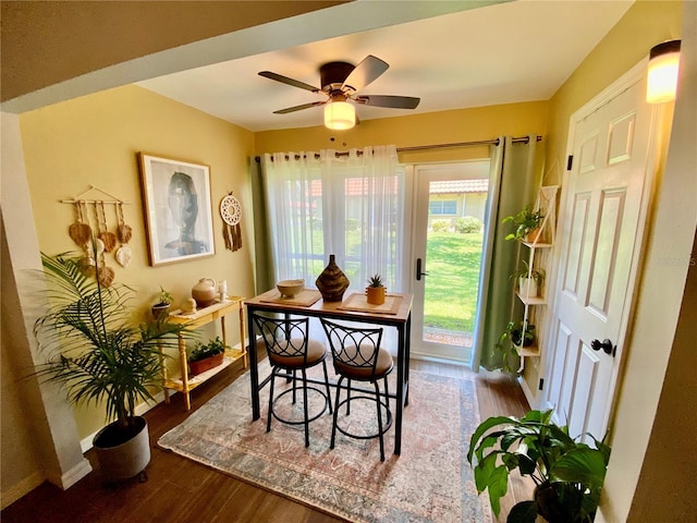 dining area with hardwood / wood-style floors and ceiling fan