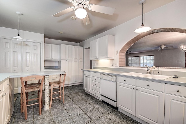 kitchen with sink, white cabinets, decorative light fixtures, white dishwasher, and ceiling fan