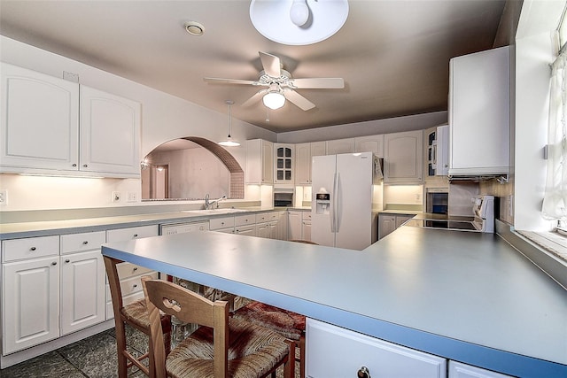 kitchen featuring sink, ceiling fan, stainless steel appliances, and white cabinets