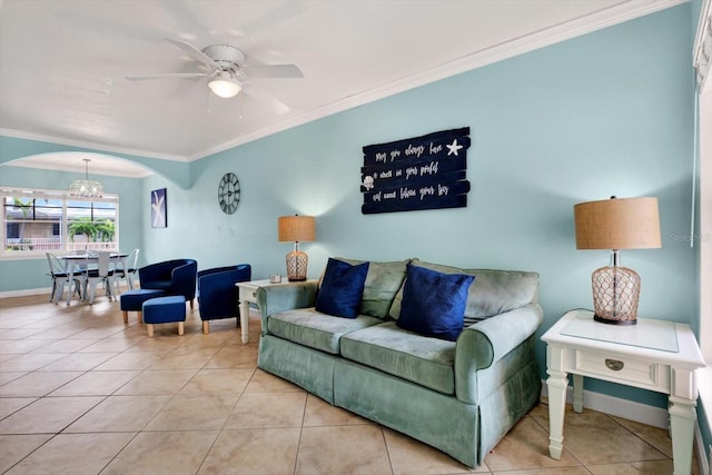 living room featuring light tile patterned floors, crown molding, and ceiling fan with notable chandelier