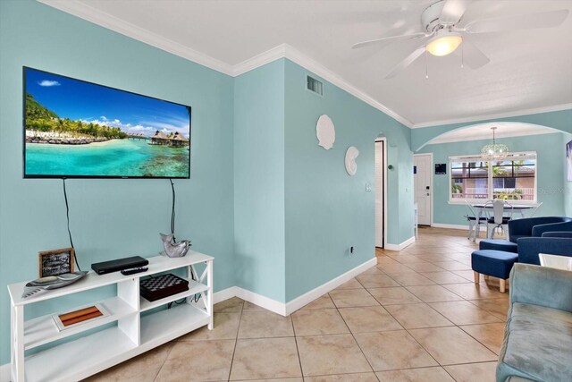 living room with ceiling fan with notable chandelier, crown molding, and light tile patterned flooring