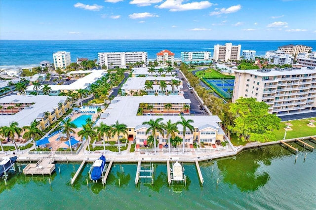 birds eye view of property featuring a water view and a city view