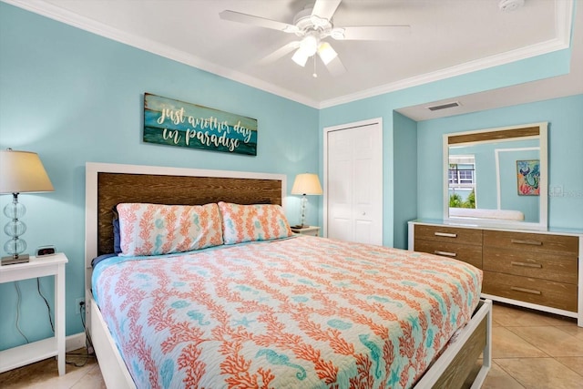 tiled bedroom with ceiling fan, a closet, and crown molding