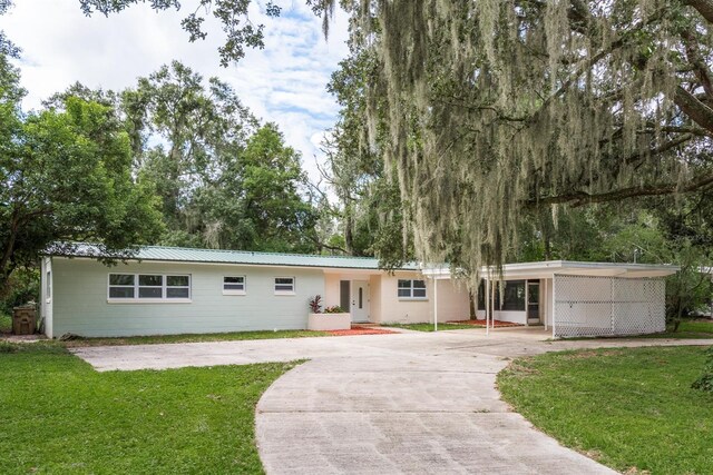 view of front of house with a front lawn and a carport