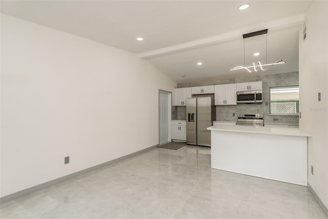 kitchen featuring decorative light fixtures, kitchen peninsula, decorative backsplash, appliances with stainless steel finishes, and white cabinets