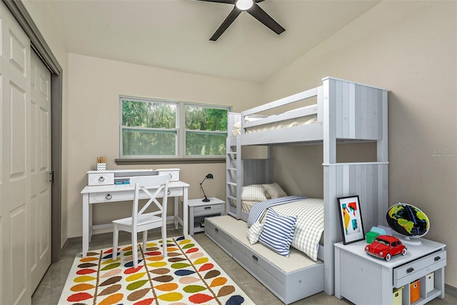 bedroom with lofted ceiling, ceiling fan, and a closet