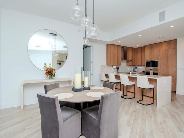 dining area with light hardwood / wood-style floors