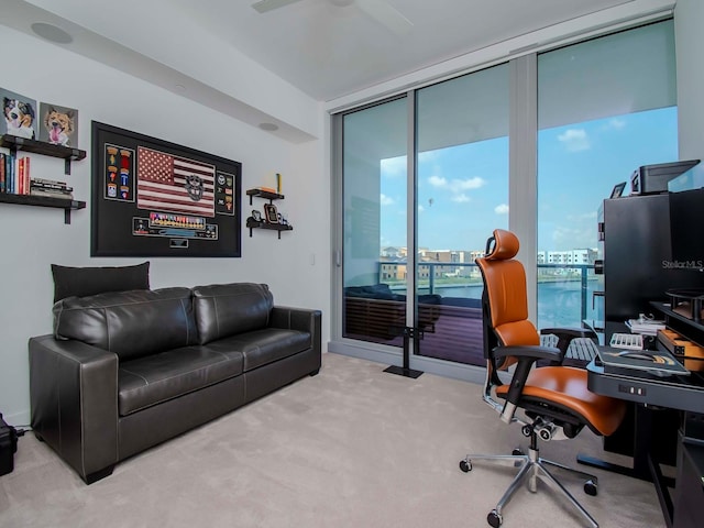 carpeted office featuring ceiling fan