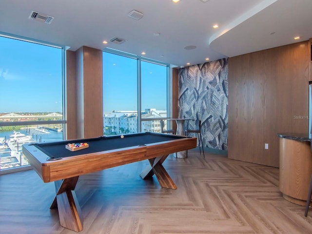 recreation room featuring a wealth of natural light, light parquet flooring, floor to ceiling windows, and billiards