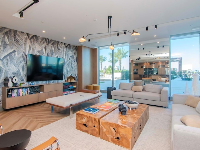 living room featuring light parquet flooring and floor to ceiling windows