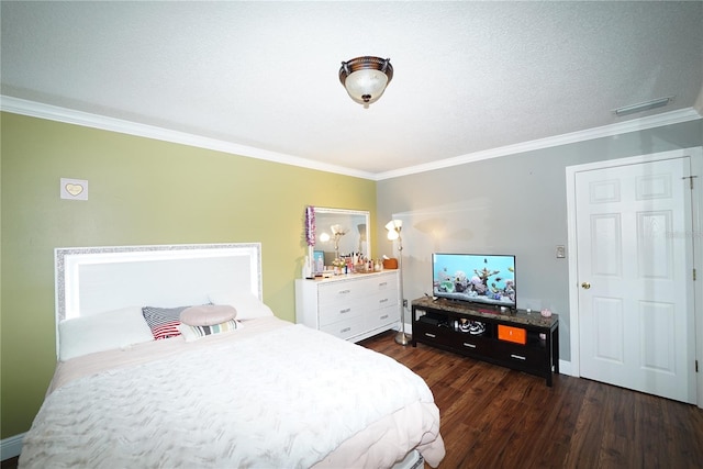 bedroom with crown molding, dark hardwood / wood-style flooring, and a textured ceiling