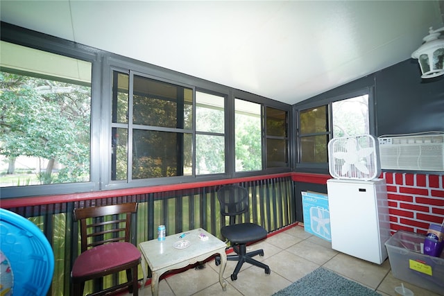 sunroom with lofted ceiling, cooling unit, and a healthy amount of sunlight