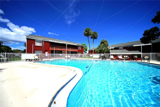 pool featuring a patio area and fence