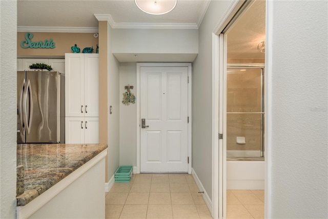 interior space featuring light tile patterned flooring and crown molding