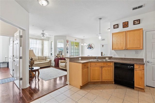 kitchen with dishwasher, light hardwood / wood-style floors, sink, pendant lighting, and ceiling fan with notable chandelier